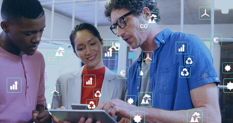 Image of ecology icons over diverse colleagues using tablet in office