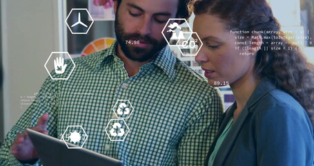 Image of ecology icons over diverse colleagues using tablet in office