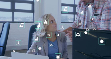 Image of ecology icons over caucasian colleagues using computer in office