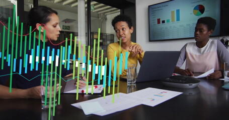 Image of green graph processing data over diverse female colleagues at casual office meeting