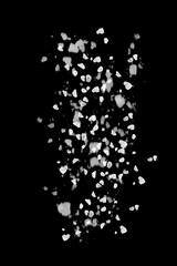 Obraz premium Sea salt grains in air on black background