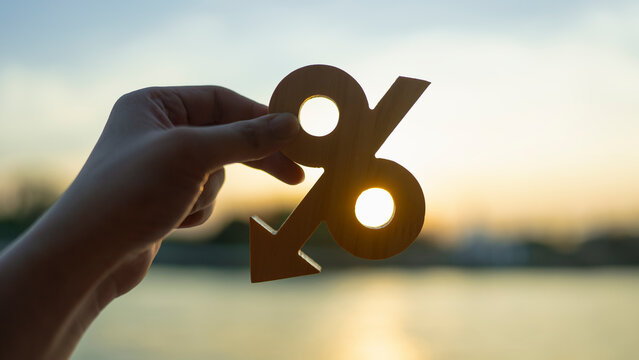 Percentage model and down arrow with evening sky. Key concepts for success, methods, systems of raising or lowering Fed interest rates to correct inflation concepts.