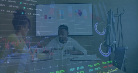 Image of data processing over diverse male and female colleague discussing at casual office