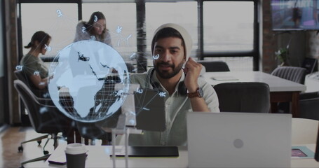 Image of globe and data processing over diverse business people in office