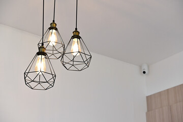 Vintage Black Metal Pendant Lights with Warm Orange Glow in Cozy Corner