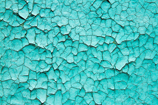 Cracked, flaky blue paint. Abstract background texture of old paint.