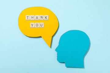 Thank you, the word is laid out from letters on a blue background.