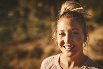 Happy woman, portrait and mountain for trip in outdoor, cityscape and freedom on vacation. Female person, nature and environment for freedom on vacation, travel and adventure on cliff for peace