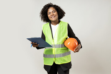 A young girl in the form of a construction worker with a hard hat