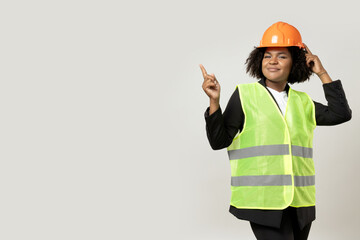 A young girl in the form of a construction worker with a hard hat