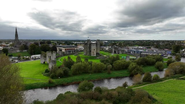 Trim Castle, County Meath, Ireland, October 2023.Drone clockwise orbit of the Norman Fortress on the banks of the River Boyne surrounded by the imposing stone walls on an overcast day.
