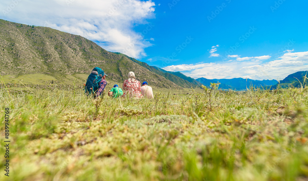 Sticker family sitting on the grass in countryside 