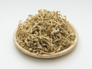 Close up of stacked dried cut radish on wooden tray and white floor, South Korea
