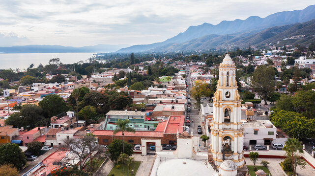Ajijic, Jalisco, Mexico - December 22, 2023: Afternoon sunlight light shines on the historic center of downtown Ajijic, surrounded by mountains and Lake Chapala.