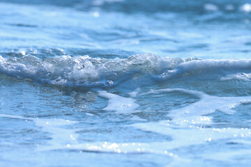 Blue sea wave on the beach. Blue water. Ocean water. Selective focus.