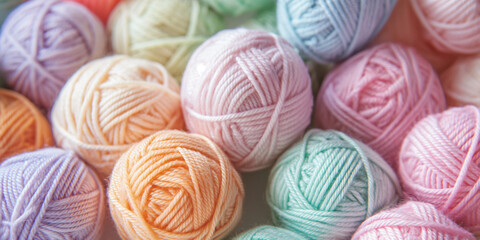 A close-up of soft, pastel-colored yarn balls arranged in an intricate pattern, symbolizing the joy and creativity that come with knitting or crocheting
