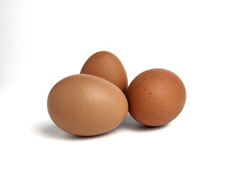 Brown chicken eggs isolated against white background