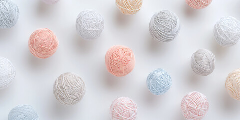 A background of pastel-colored linen yarn balls, each with its shadow, scattered across the canvas in an elegant display, with soft shadows on a white background
