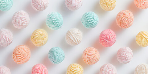 A background of pastel-colored novelty yarn balls, each with its shadow, scattered across the canvas in an elegant display, with soft shadows on a white background