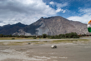 the river with blue sky and sandstone mountains in nubra valley, leh ladakh, india