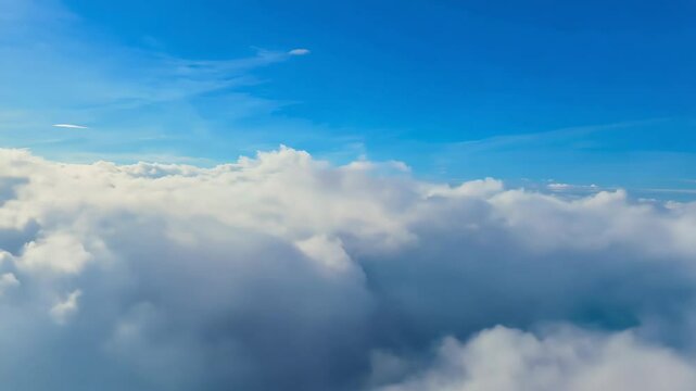 Flying through and over clouds, blue sky background