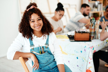 Portrait, woman and happy in art studio for painting and creativity or talent and group in workshop. Female artist, gen z and face with smile for acrylic or design with paintbrushes and friends