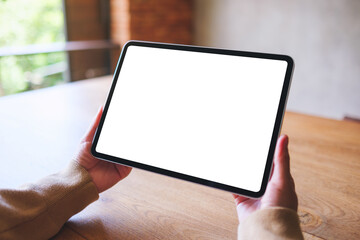Mockup image of a woman holding digital tablet with blank white desktop screen