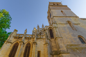 Cathedral Saint-Nazaire-A river runs through a town with a castle in the background