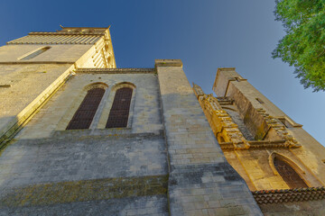 Cathedral Saint-Nazaire-A river runs through a town with a castle in the background