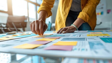 Fototapeta premium A visually impaired entrepreneur using tactile graphics to present a business plan to investors Stock Photo with copy space