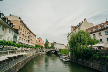 Naklejka premium Cityscape view on Ljubljanica river canal in Ljubljana old town.
