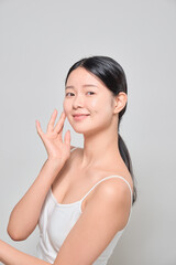 Female model smiling with confidence after applying makeup.