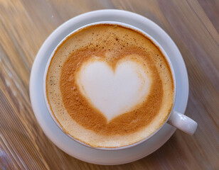 Fototapeta premium Top-Down View of Latte Art Heart Shape on Cappuccino with Steam Rising