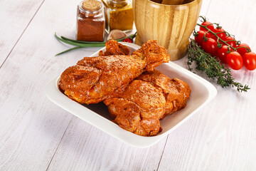 Raw turkey shoulder wing in Indian tandoori marinade