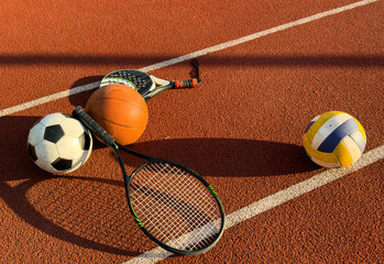 Set of sport equipment, rackets and tennis balls soccer and basketball balls
