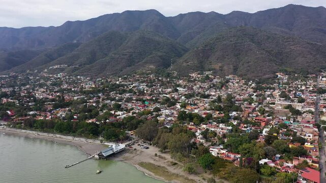Ajijic, Jalisco, Mexico - December 22, 2023: Afternoon sunlight light shines on the historic center of downtown Ajijic, surrounded by mountains and Lake Chapala.