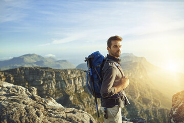 Man, mountain and backpacking for outdoor vacation, travel and hiking in nature for tourism journey. Male person, trekking and athlete for sky mockup space, adventure and exercise for holiday workout