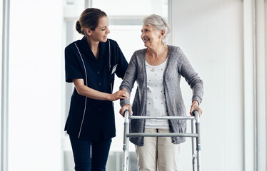 Support, caregiver and senior woman with walker for assistance, help or medical care in retirement...