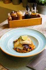 Top down of Grilled Halibut fish with Andalusian Ratatouille and a slice of lime