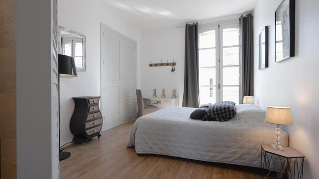 Slow establishing shot of a master bedroom with an open plan bathroom in a villa