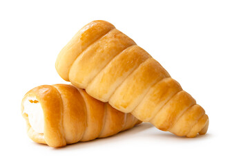 Side view of brown puff pastry cream horns in stack isolated on white background with clipping path