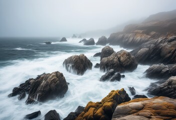 Obraz premium soothing ocean mist drifts over sharp jagged rocks coastal scene, water, waves, splashing, nature, seascape, shoreline, cliffs, rugged, serene, peaceful