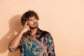 Photo portrait of attractive young man look skeptical minded empty space dressed stylish print...