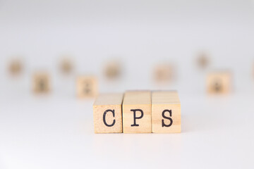 CPS acronym - concept of Cyber-Physical Systems or Cost Per Sale written on wooden cubes on white background with copy space.