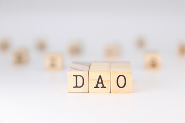 DAO Acronym - Concept of Decentralized Autonomous Organizations written on wooden cubes isolated on white background with copy space for the text 
