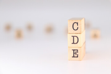 CDE acronym - Concept of Collaborative Data Exchange written on wooden cubes isolated on white background with copy space for text.