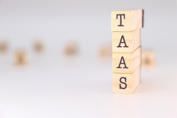 TaaS acronym - Transportation as a Service concept written on wooden cubes on white background with copy space.