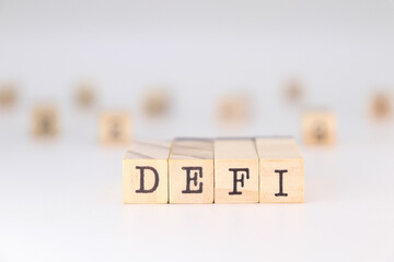 DeFi acronym - Decentralized Finance concept written on wooden cubes on white background with copy space.
