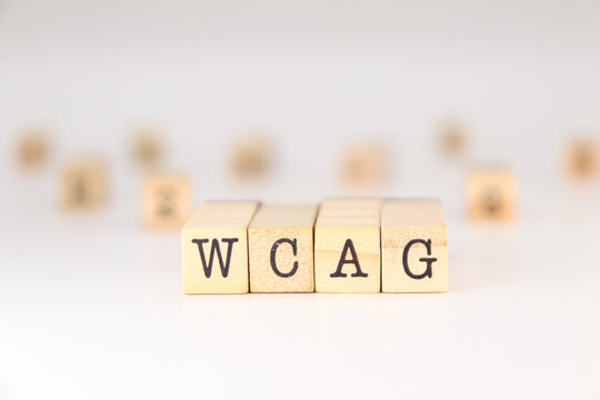 WCAG acronym - Concept of Web Content Accessibility Guidelines written on wooden cubes isolated on white background with copy space for text phrase.