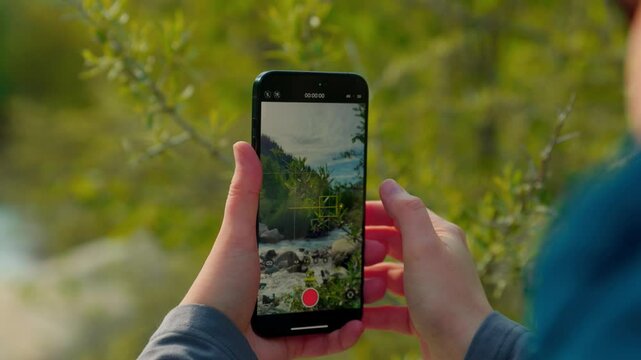 Woman traveler make video by smartphone of nature landscape